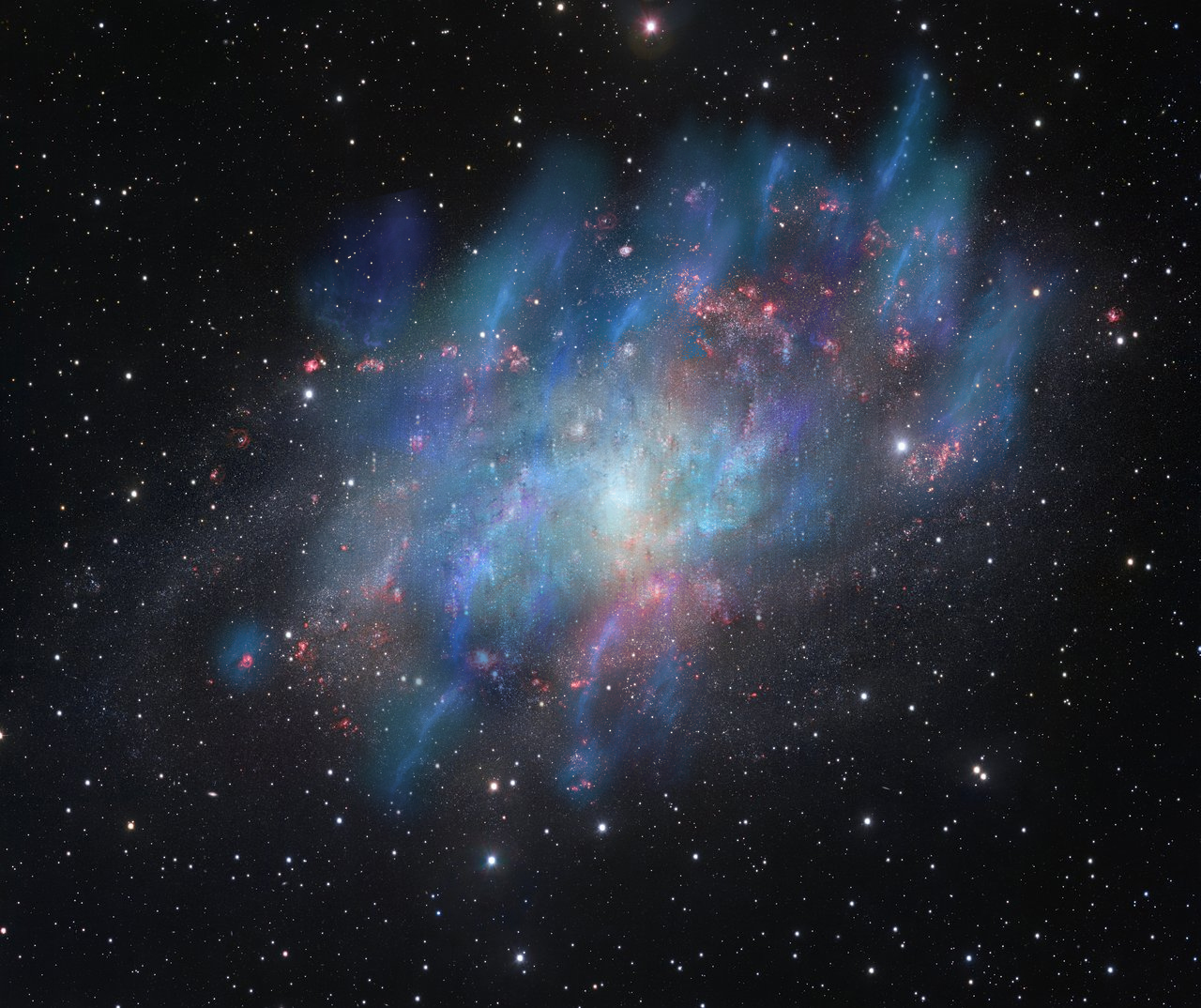 Figure 1: Artist’s illustration of the nonthermal feedback [40] in star-forming regions (blue and green) superimposed on a VLT visible-light image (red and white). Credit: Institute for Research in Fundamental Sciences- IPM & European Southern Observatory (ESO).